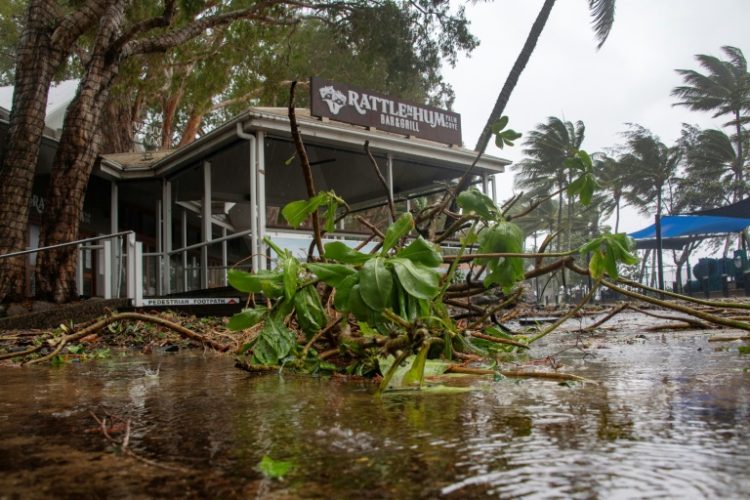 A bar restaurant is seen past fallen branches in Palm Cove as Cyclone Jasper approaches landfall near Cairns in far north Queensland on December 13, 2023. . ©AFP