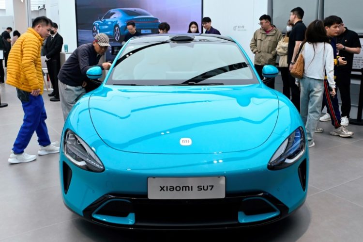 A Xiaomi SU7 electric car is displayed at a Xiaomi store in Beijing on March 26, 2024.. ©AFP