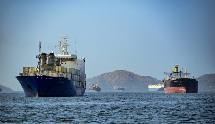Cargo ships wait to cross the Panama Canal in Panama City . ©AFP