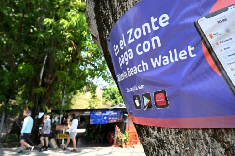 A sign promoting bitcoin transactions is seen in the beach town of El Zonte in El Salvador. ©AFP