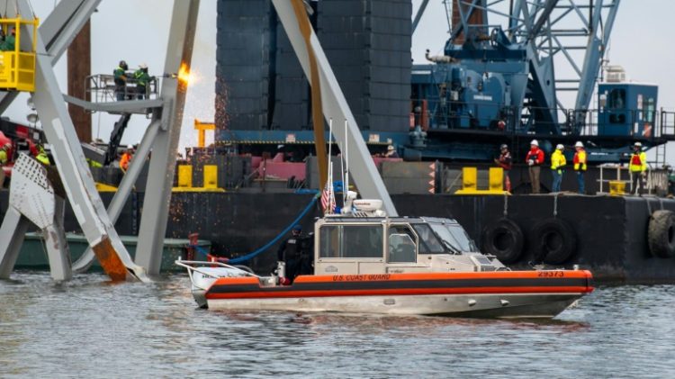 US authorities hope to create a temporary channel while they remove the wreckage of Baltimore's Francis Scott Key Bridge, seen here in this handout photo from the Coast Guard . ©AFP