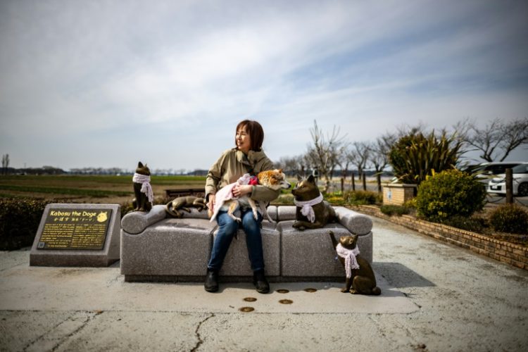 Atsuko Sato sits with her Japanese shiba inu dog Kabosu, best known as the face of the cryptocurrency Dogecoin. ©AFP