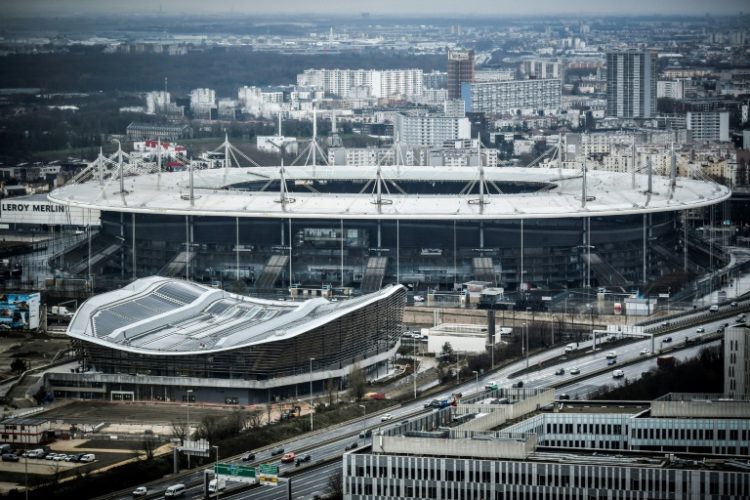 The Olympic Aquatics Centre (foreground), the renovated Stade de France and the footbridge that will join them have added to the bill for Paris. ©AFP