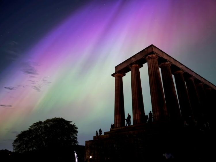 This handout photo taken and released by Jacob Anderson shows the northern lights, or aurora borealis, during a solar storm over the National Monument of Scotland in Edinburgh. ©AFP