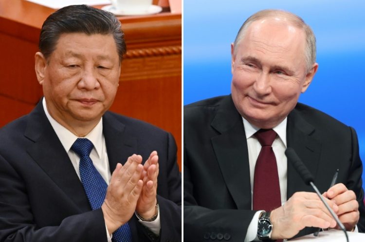 Chinese President Xi Jinping (L) and Russian leader Vladimir Putin praised their countries' roles in global affairs at a meeting in Beijing on Thursday. ©AFP