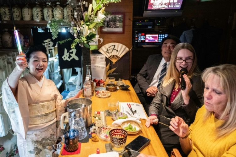 Japan's snack bars are cosy, retro establishments often crammed into small buildings and equipped with karaoke systems that echo late into the night. ©AFP