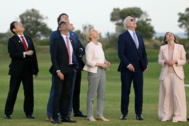 G7 leaders attend a skydiving demonstration at the San Domenico Golf Course in Savelletri, Italy . ©AFP