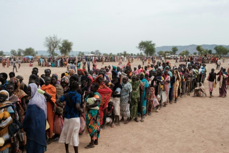 People line up to register for potential food aid delivery at a camp for internally displaced persons in Agari, South Kordofan, on June 17, 2024. ©AFP