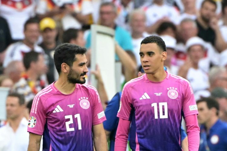 Midfielders Ilkay Gundogan Jamal Musiala in Germany's pink and purple jerseys after winning the UEFA Euro 2024 Group A football match against Hungary on June 19. ©AFP