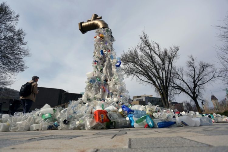 A sculpture titled "Giant Plastic Tap" by Canadian artist Benjamin Von Wong is displayed outside the fourth session of the UN Intergovernmental Negotiating Committee on Plastic Pollution in Ottawa, Canada, on April 23, 2024. ©AFP