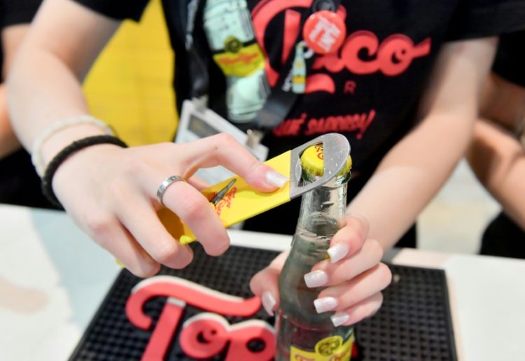 Strong sales of the Topo Chico seltzer brand helped lift Coca-Cola to better than expected profits. ©AFP