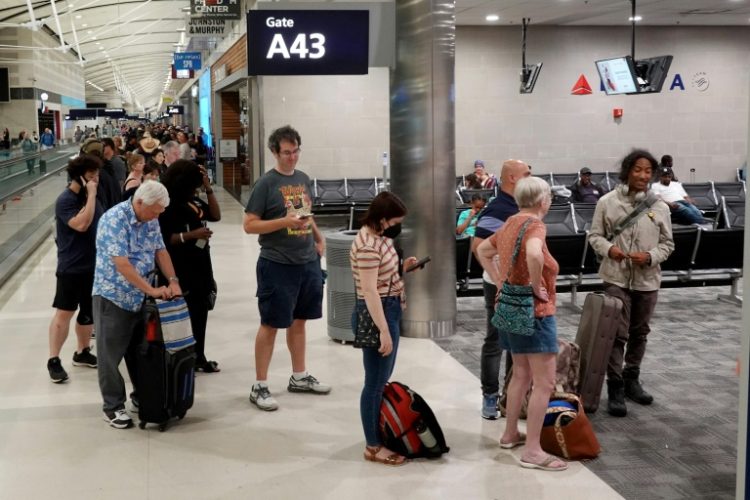 Travelers wait in a long line to speak with a Delta representative at the help desk in the McNamara terminal at the Detroit Metropolitan Wayne County Airport on July 20, 2024. ©AFP