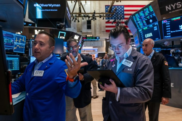 The Dow soared more than 740 points following a bullish reaction to solid earnings as markets bet on Federal Reserve interest rate cuts . ©AFP