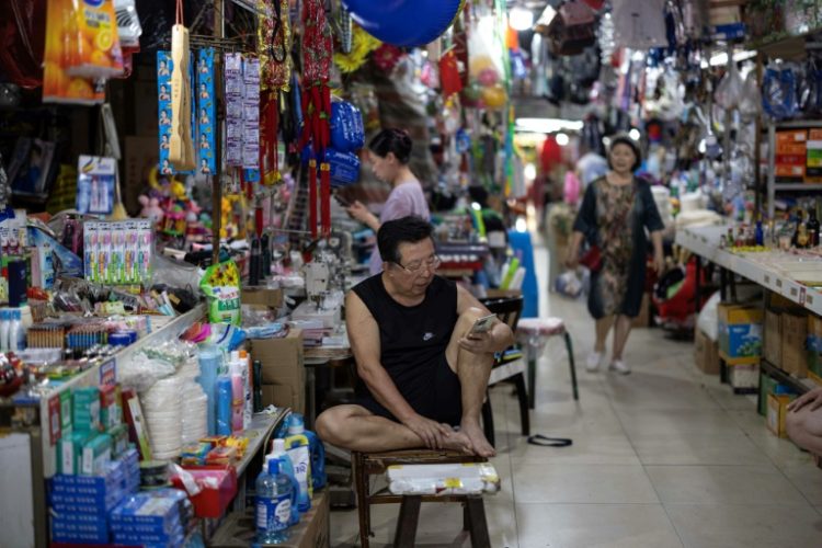 Consumer spending in China rose in July but was outpaced by manufacturing. ©AFP