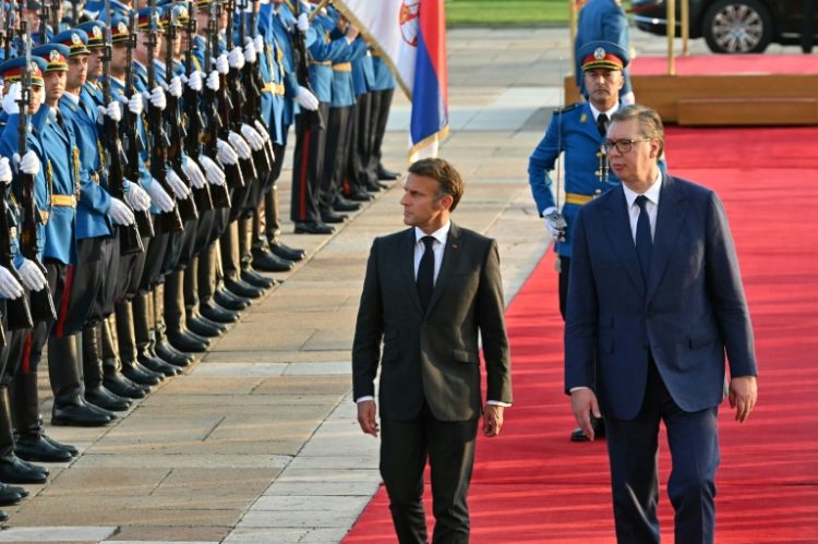 Macron arrived in Belgrade where he was greeted with a hug by Vucic and a traditional honour guard. ©AFP