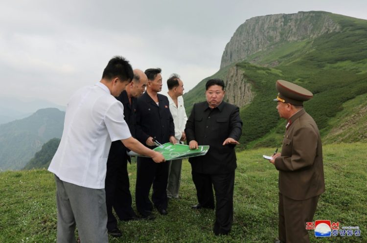 Kim Jong Un (C) has poured huge resources into developing the Samjiyon area, with the vast project including new apartments, hotels and a ski resort. ©AFP