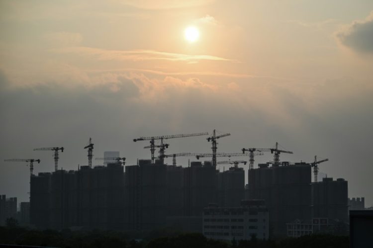 Buildings under construction are seen during sunset in Shanghai on September 6, 2024.. ©AFP