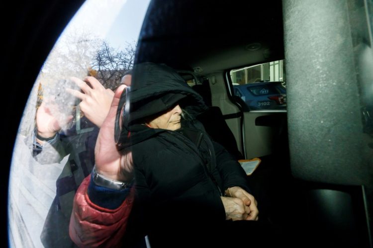 Seen through a police vehicle window, Canadian fashion mogul Peter Nygard leaves a Toronto courthouse in November 2023 after being found guilty of four counts of sexual assault. ©AFP