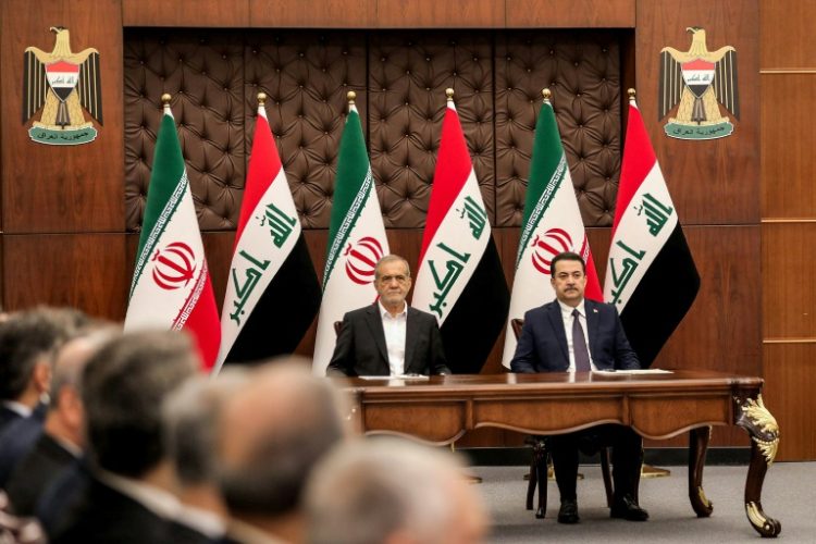 Iraqi Prime Minister Mohammed Shia al-Sudani (R) and Iranian President Masoud Pezeshkian attend a ceremony for the signing of memoranda of understanding in Baghdad. ©AFP