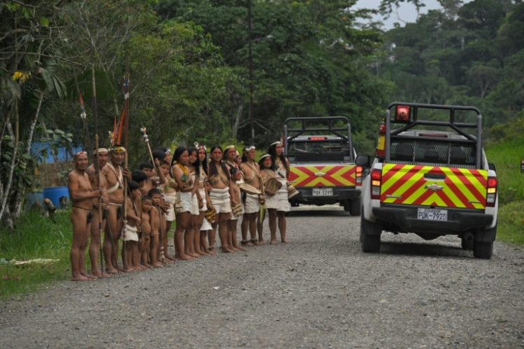 Waorani indigenous people look at Petroecuador company trucks passing by Guiyero Waorani village within the Yasuni National Park in the province of Orellana, Ecuador, on August  27, 2024. ©AFP