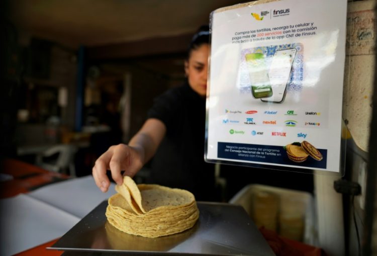 A sign at a shop in Mexico City tells customers about a new application they can use to buy tortillas . ©AFP