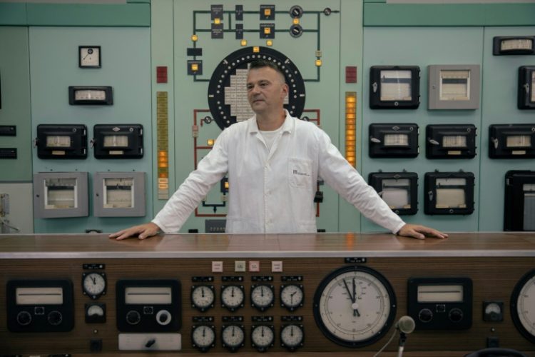 Dalibor Arbutina, director of Public Company Nuclear Facilities of Serbia (NFS), stands in the control room of a decommissioned nuclear reactor. ©AFP