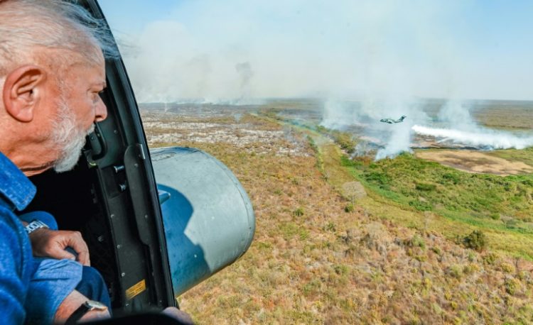 President Luiz Inacio Lula da Silva looking out at fires burning in the Pantanal . ©AFP