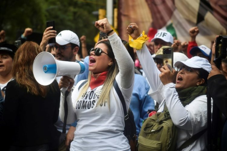 Opponents of Mexico's controversial judicial reforms protest outside the Senate after the bill was passed. ©AFP