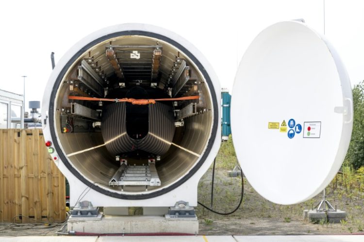 The dark and light grey striped pod inside the hyperloop tunnel at the European Hyperloop Center (EHC) testing facility in Veendam. ©AFP