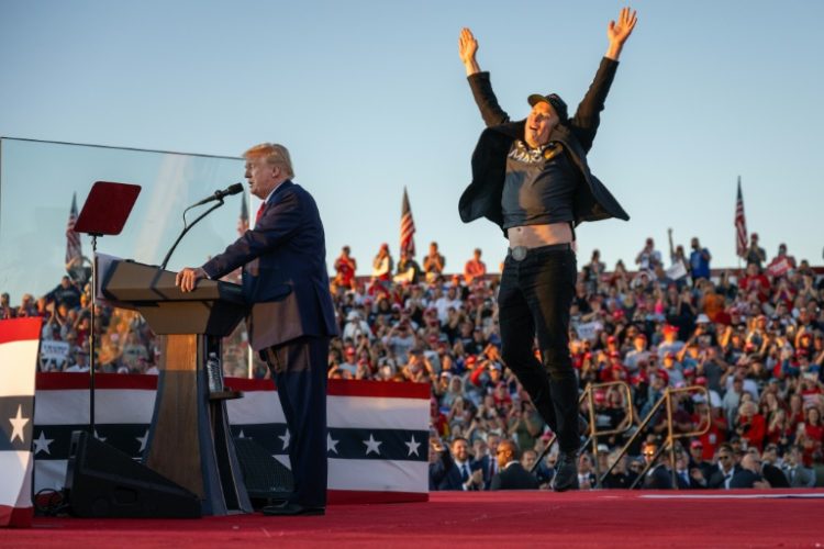 Tesla CEO Elon Musk jumps on stage as he joins former US president and Republican presidential candidate Donald Trump during a campaign rally . ©AFP