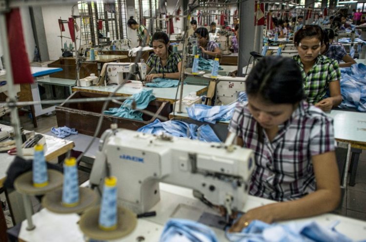 A civil war is devastating Myanmar, but thousands of garment workers in the country still churn out clothing for brands like Adidas and H&M. ©AFP