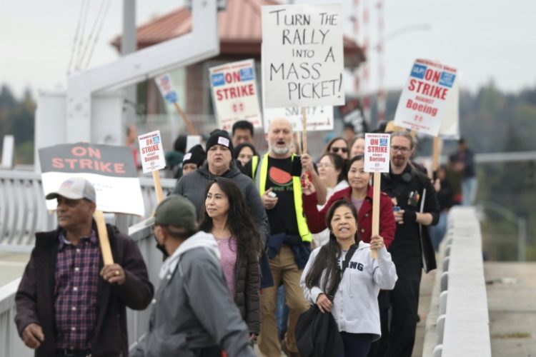 Striking workers with the International Association of Machinists and Aerospace Workers will weigh Boeing's latest offer after voting down two previous contracts . ©AFP