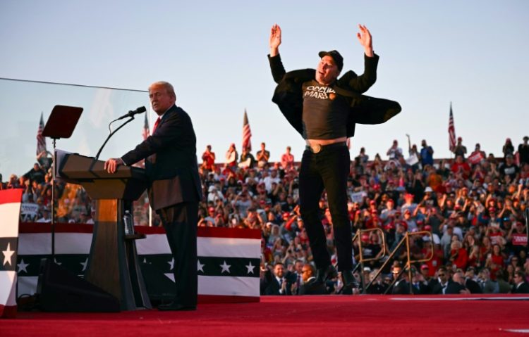 Elon Musk (R), shown joining Donald Trump on stage at a rally in Pennsylvania in October, is poised to have sweeping powers in the Republican's new administration. ©AFP