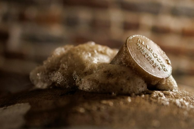 Foam coming out of a barrel containing 'lambic' in the process of aging at Cantillon brewery in Brussels. ©AFP