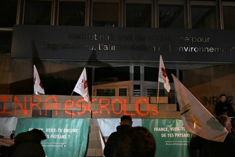 Protesters erected a brick wall in front of France's agricultural research institute. ©AFP