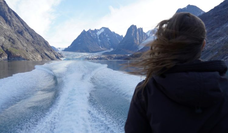 A woman looks out from a tour boat as it sails away from a glacier between Maniitsoq and Sisimiut in Greeceland . ©AFP