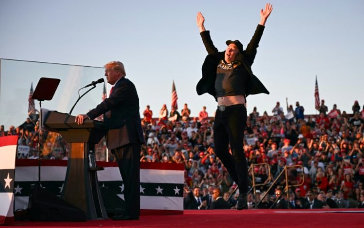 Tesla and SpaceX CEO Elon Musk exults during a Donald Trump rally in Pennsylvania in October 2024 -- the pair have become fast friends. ©AFP