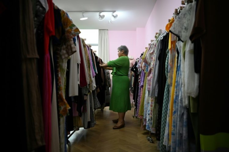 Plus-size clothing brand owner and influencer Amanda Yao inspects clothes in her office in Guangzhou. ©AFP