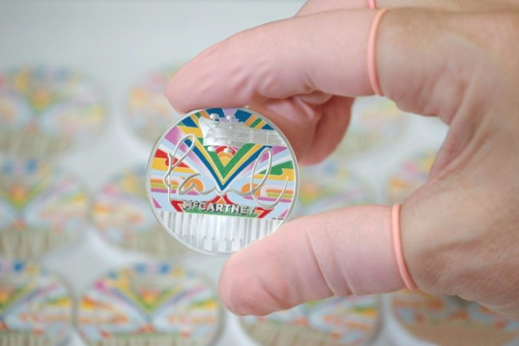 The coin's design includes the psychedelic 'magic piano' featured in the 1967 Magical Mystery Tour film. ©AFP