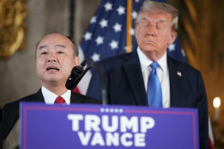 SoftBank CEO Masayoshi Son delivers remarks while US President-elect Donald Trump looks on at Mar-a-Lago in Florida on December 16, 2024. ©AFP