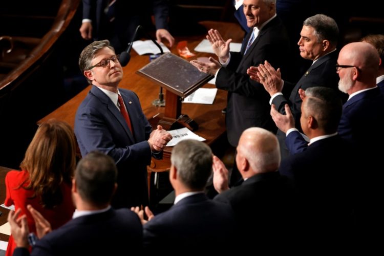 Mike Johnson, seen receiving applause after being re-elected speaker of the US House of Representatives, says he hopes for speedy passage of a massive bill full of Donald Trump's priorities . ©AFP