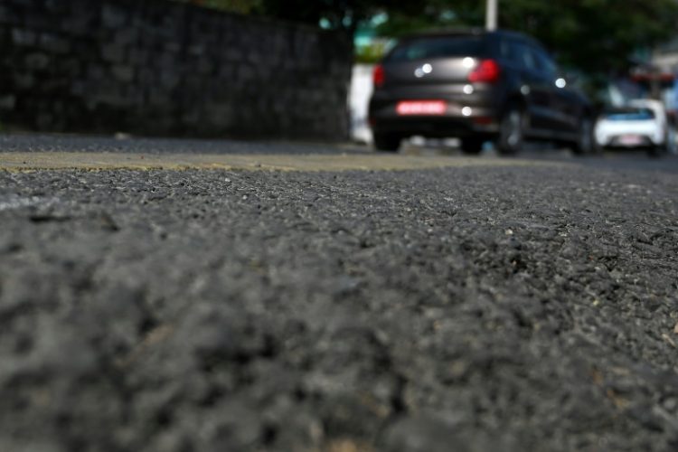 Vehicles riding over a road built using recycled plastic waste in Pokhara. ©AFP