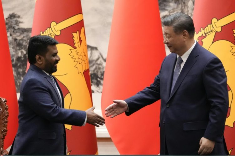 Chinese President Xi Jinping (R) shakes hands with Sri Lankan President Anura Kumara Dissanayake during a signing ceremony at the Great Hall of the People in Beijing on January 15, 2025. ©AFP