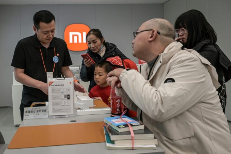 China has introduced incentives to get the country's consumers back into shops, with subsidies for a range of goods including smartphones and microwave ovens. ©AFP