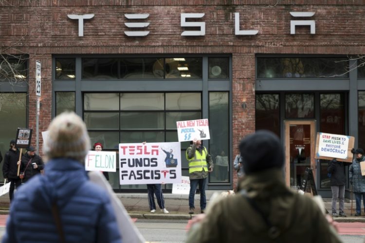 Anti-Elon Musk protesters have taken to Tesla showrooms across the United States. ©AFP