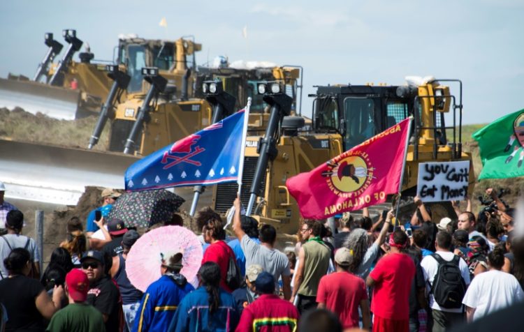 Members of the Standing Rock Sioux Tribe and their supporters opposed to the Dakota Access Pipeline (DAPL) confront bulldozers working on the new oil pipeline in an effort to make them stop on September 3, 2016, near Cannon Ball, North Dakota. ©AFP