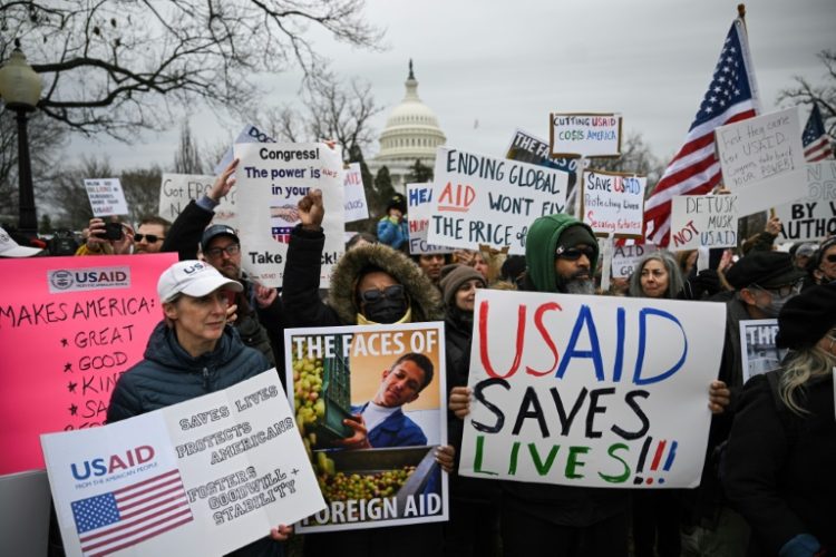 People protest in Washington against President Donald Trump's administration's efforts to shutter the US Agency for International Development and lay off thousands of federal employees. ©AFP