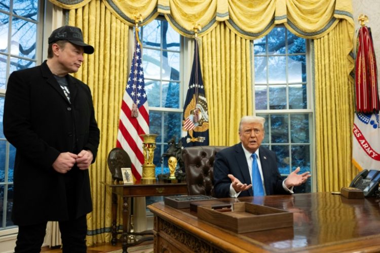 Tesla and SpaceX founder Elon Musk listens as US President Donald Trump speaks to reporters in the Oval Office of the White House. ©AFP