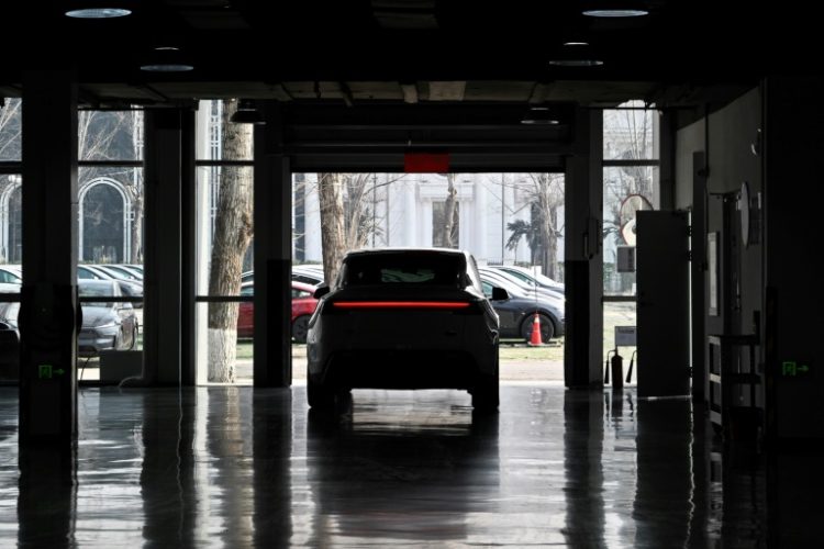 A buyer drives a new Model Y car at Tesla's Xiedao delivery centre in Beijing in February 2025. ©AFP