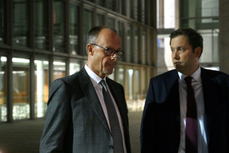 Defense stocks lifted European bourses on news that the likely next German chancellor, Friedrich Merz (L), shown here with Germany's Social Democratic Party (SPD) Chairman Lars Klingbeil, plans heavy investment in military programs . ©AFP